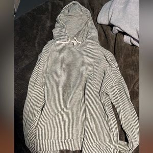 Green striped shirt with pockets and hood.